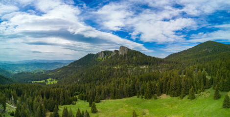 Peak with vegetation and forests against clouds in valley of Rhodope Mountains. Panorama, top view