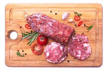 Sliced Smoked dry Salami sausage on wooden cutting board isolated on white background