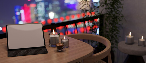 Tablet with wireless keyboard mockup and candles on table at the apartment balcony at night