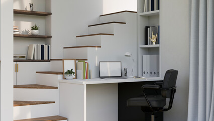 Home working space in minimal white style with laptop on white desk against the staircase