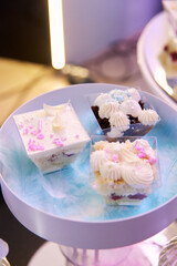 Bright mouth-watering sweets on a colored table during the holiday