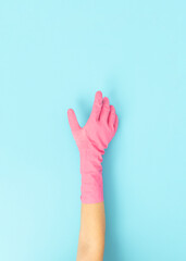 woman in dishwashing gloves holding dish sponge doing cleaning