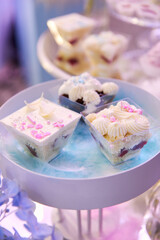 Bright mouth-watering sweets on a colored table during the holiday