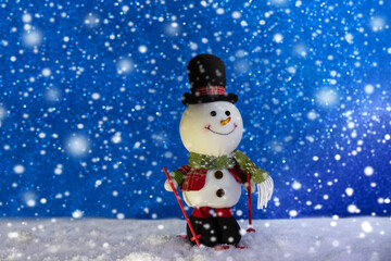 Happy snowman standing in winter sparkling christmas landscape. Merry christmas and happy new year...