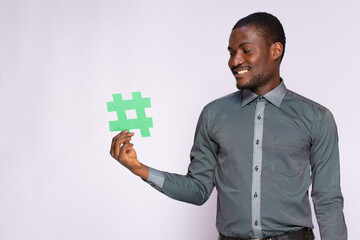 african businessman holding a hash tag symbol