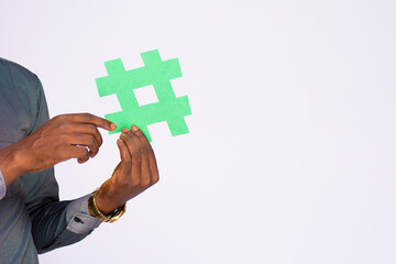 african businessman holding a hash tag symbol