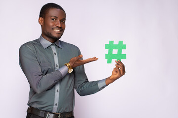 african businessman holding a hash tag symbol