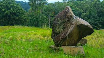 stacked stones piled in the beautiful green grass