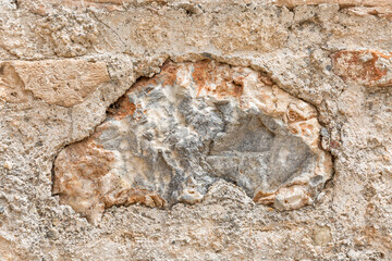 Surface of beige sandy rock. Durable building material and archaeological site. Background. Space for text.