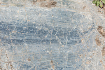 Fototapeta premium Surface of gray-beige sandy rock. Durable building material and archaeological site. Background. Space for text.