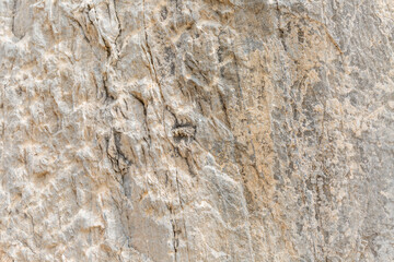 Surface of beige sandy rock. Durable building material and archaeological site. Background. Space for text.