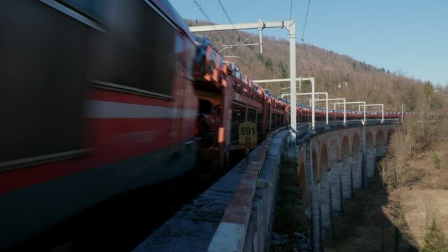 Train on a Bridge Carrying Cars