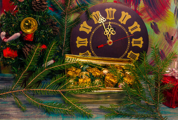 Christmas wooden background with clock and fir branches.