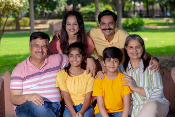 Happy indian or asian family at park