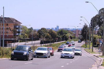 Cars travelling east on Parramatta road Ashfield.  The entrance to the M4 tunnel can be seen on the opposite side of the road