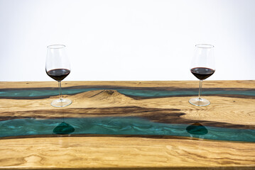 Coffee table, living room table. Resin handmade wood table. On a white background. Glass of whisky and glass of wine on the table.