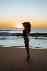 Fototapeta na wymiar Girl on the beach sunset