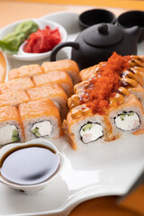 sushi and rolls on an orange background