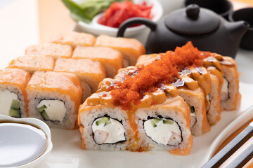 sushi and rolls on an orange background