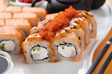 sushi and rolls on an orange background