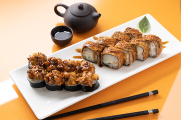 sushi and rolls on an orange background