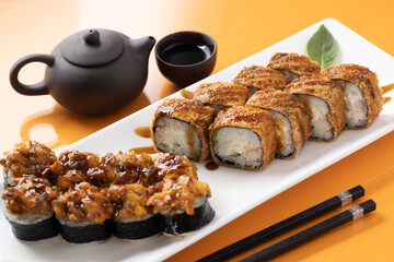 sushi and rolls on an orange background