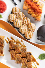 sushi and rolls on an orange background