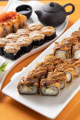 sushi and rolls on an orange background