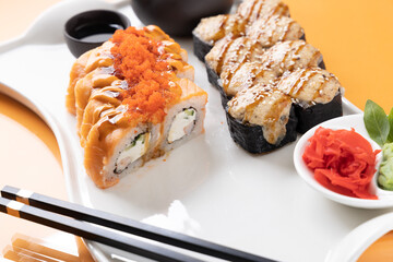 sushi and rolls on an orange background