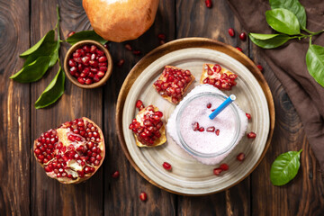 Fototapeta na wymiar Vegan protein smoothie made from pomegranate and banana on a rustic wooden table. Healthy food, healthy lifestyle. Foodism, raw food diet. Top view flat lay.