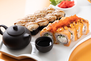 sushi and rolls on an orange background
