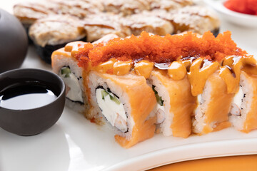 sushi and rolls on an orange background