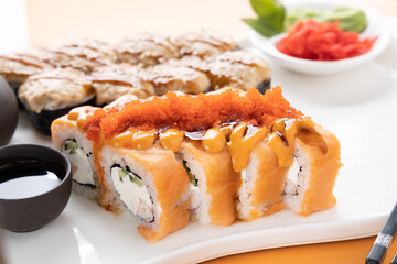 sushi and rolls on an orange background