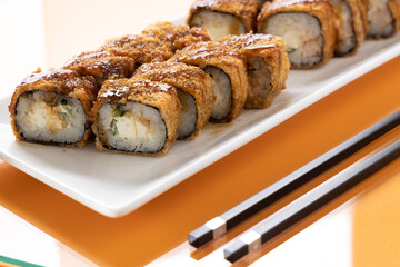 sushi and rolls on an orange background