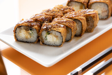 sushi and rolls on an orange background