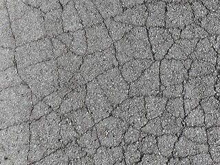 Cracked asphalt road. Cracked sidewalk texture pattern background.