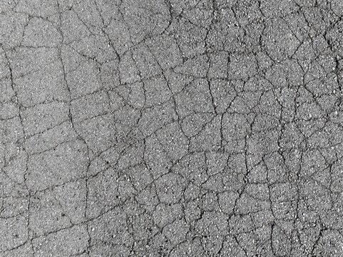 Cracked asphalt road. Cracked sidewalk texture pattern background.