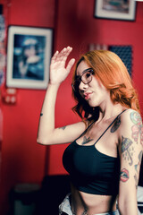 Portrait of a girl with a tattoo on her shoulder in a modern studio lowlight.