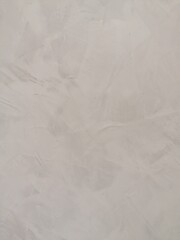 Fondo abstracto con detalle de superficie con suave estucado en tonos grises y degradado de luz