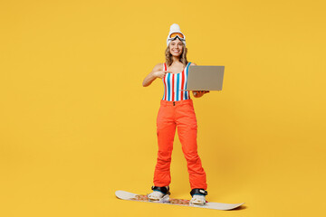 Snowboarder woman wear orange ski suit goggles mask hat swimsuit spend extreme weekend use show...