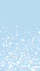 Magic falling snow christmas background. Subtle flying snow flakes and stars on light blue winter backdrop. Magic falling snow holiday scenery.   Vertical vector illustration.