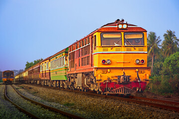 Passenger train by diesel locomotive on the railway.