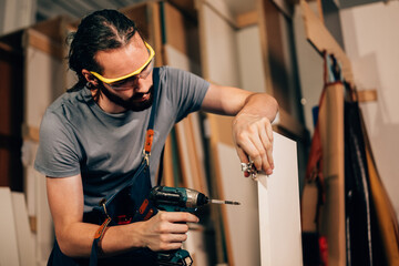Carpenter portrait, Carpenter working creating furniture in workshop. carpentry and furniture...