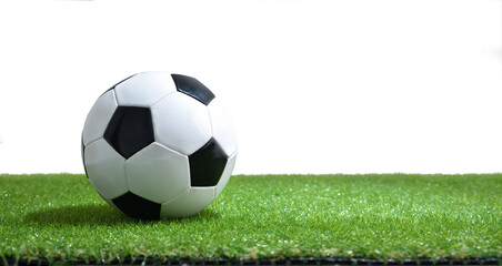 Soccer ball on synthetic grass and white isolated background