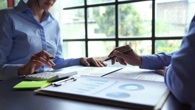 Businessman accountant using calculator and laptop for calculating finance on desk office. business financial accounting concept.