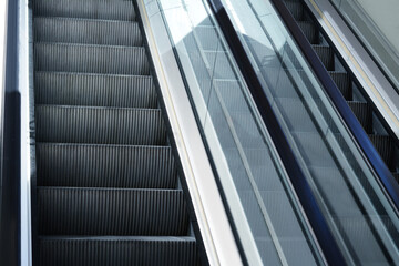Obraz premium Modern escalators with handrails in shopping mall, closeup