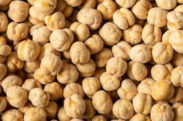 Roasted salty yellow chickpeas textured background, traditional turkish nut, leblebi