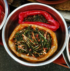 Plastic pot of chilli onions on display for sale in South Korean street market