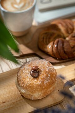 Vertical shot of an Italian bombolone donut filled with chocolate, hazelnut on the top