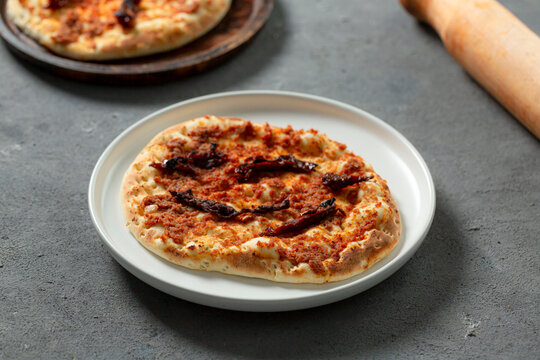 Manakish Dried Tomatoes  Yellow Cheese Manakish (مناقيش) On A Gray Background, Top View